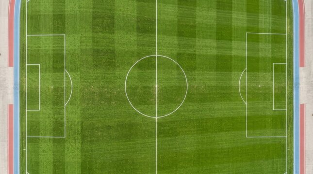 Aerial view of empty soccer field with white markings.