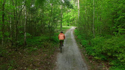 Fototapeta premium Outdoor cyclist enjoying nature trail in spring forest