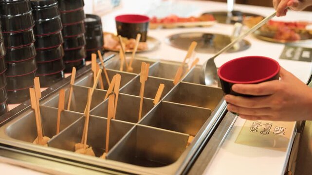 Close Up of Korean Fish Cake Odeng Skewers in Hot Broth