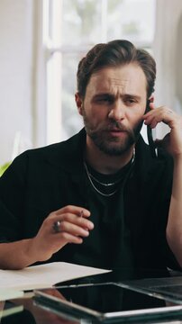 Businessman, barbershop and writing with phone call for online booking, schedule or appointment. Man, stylist or talking with smartphone, diary or notebook for customer service or reminder in salon
