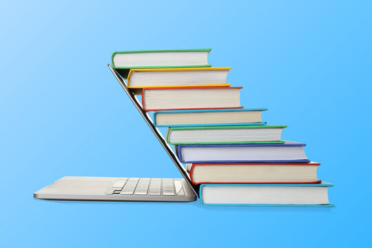 Books arranged on a laptop to show study tools for learners