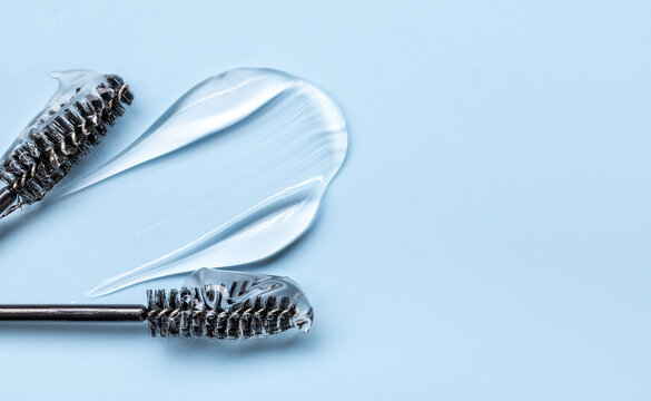 transparent eyelash eyebrow gel serum, smooth and shiny texture stroke, blue background