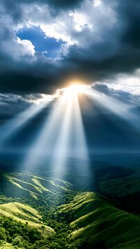 Aerial View of Sunbeams Breaking Through Storm Clouds Over Green Hills | Vertical Video