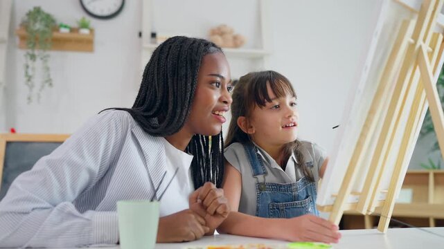 African woman tutor guide young child through art and painting in nursery.
