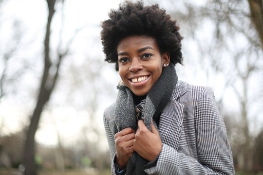 Happy Black woman with natural hair smiling outdoors