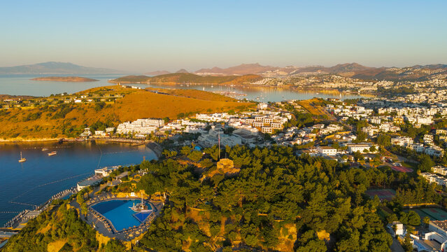 Bodrum, Turkey. Distant aerial drone view of Tiger Tower within restricted military zone. Ancient watchtower on wooded hilltop, visible from town but inaccessible to public.. Aerial View