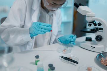 Fototapeta premium Biomedical scientists conduct laboratory experiments using microscopes, laboratory glassware, and biological samples to support medical research, diagnostics, biotechnology, and healthcare innovation.