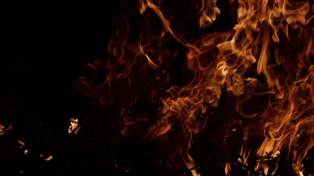 Fire slow motion flames dancing freely. Fire slow motion burning organic movement. Fire slow motion glowing warm light. Fire slow motion cinematic texture.
