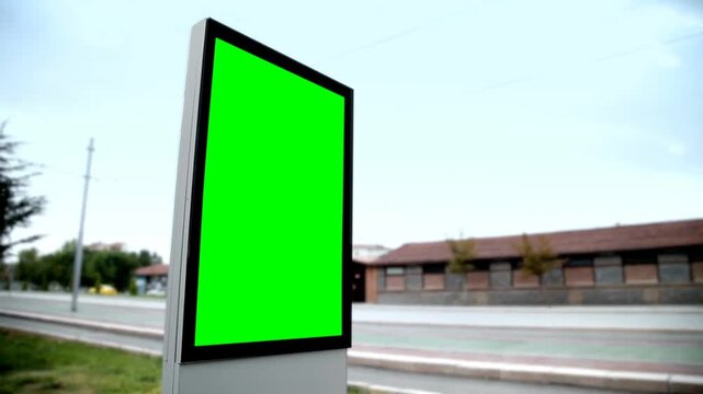 Outdoor vertical billboard video (city light poster/billboard) with a bright green empty green screen.