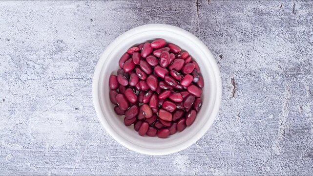 Stopmotion: eating red beans from a white saucer