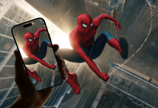 Spider-Man Brand New Day Falling Superhero Scene Displayed on Smartphone Held in Hand Matching Blurred Background Image