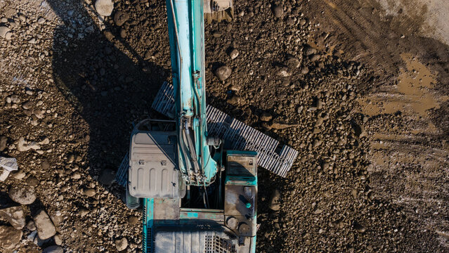 Aerial Scenery of Excavator Operating in Rock Quarry Mine with Gravel and Boulder Extraction, Construction and mining site view from above.