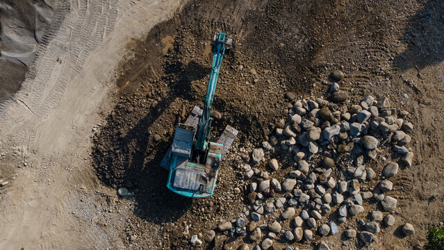 Aerial Scenery of Excavator Operating in Rock Quarry Mine with Gravel and Boulder Extraction, Construction and mining site view from above.