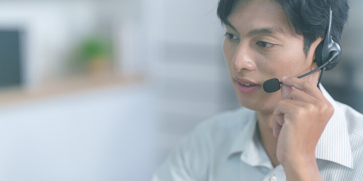 Close up of Asian male customer support agent with headset in office