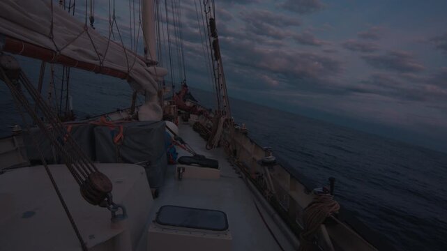 Sailing boat sails in the sea at twilight. Details of the sailing boat