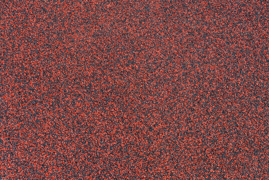 Red and gray rubber safety surface texture for playground, colorful EPDM crumb paving close-up background