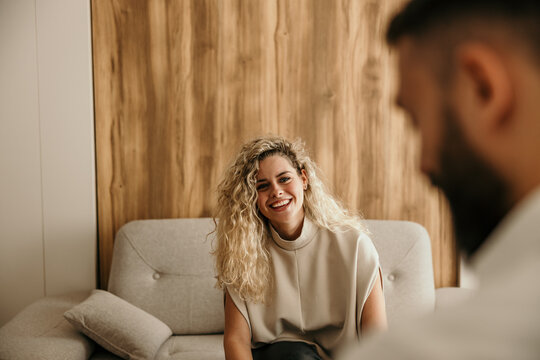 Woman client smiling during therapy session with therapist