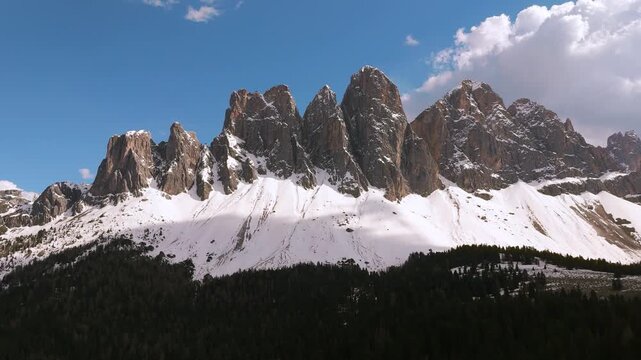 Puez-Geisler Odle mountain range in Italy, limestone peak towers. Val di Funes aerial. Dolomites.