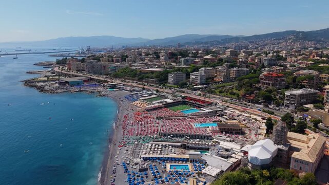 Aerial drone shot of crowded Corso Italia beach and coastline in Genova, Italy