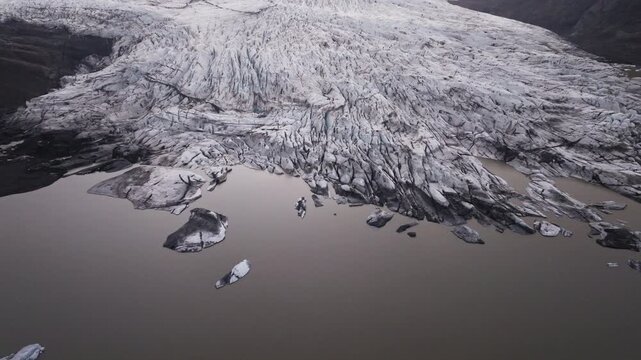 High aerial view of Hoffellsj&ouml;kull outlet glacier with murky water in Iceland