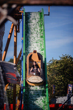 Exciting log flume drop with family enjoying summer amusement park ride