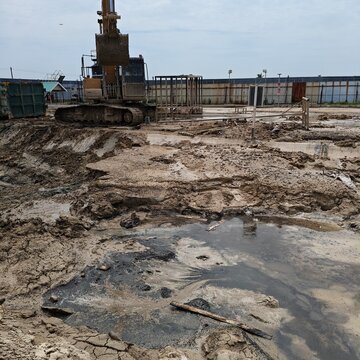 Heavy Excavator Machine Working at Industrial Construction Site with Mud and Ground Texture