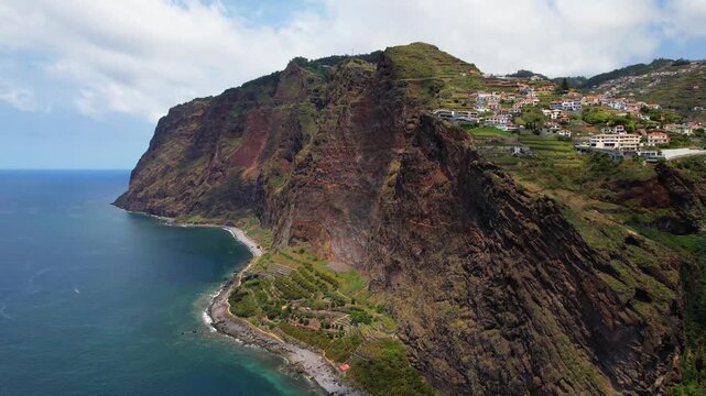 Faja dos Padres Madeira Portugal Aerial Drone Flyback Flight Along Steep Vertical Coastal Cliffs Terraces Green Fields Quinta Grande Village Camara de Lobos Atlantic Travel Video 4K UHD