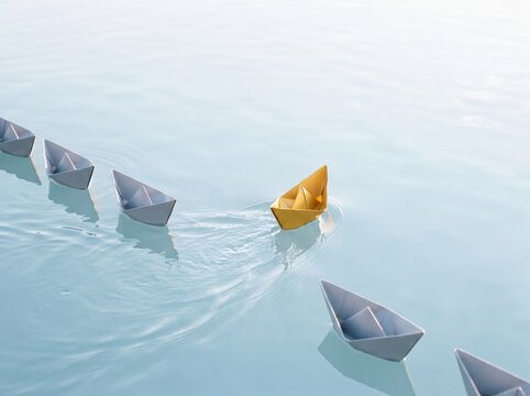 Gold paper boat veering off from white boats on water, individuality