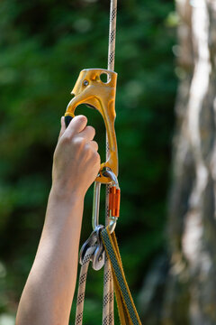 Person ascending rope using climbing ascender equipment