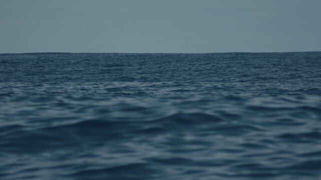 Open ocean with waves as seen from the moving sailing vessel