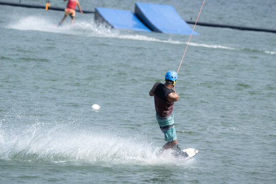 Cable Wakeboarder Riding on Lake in Summer