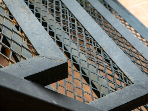Industrial Expanded Metal Mesh Staircase Grating, Rusty Steel Texture Close-Up