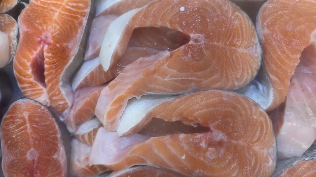 Salmon fillets freshly cut with visible marbling, ideal for cooking recipes or culinary backgrounds