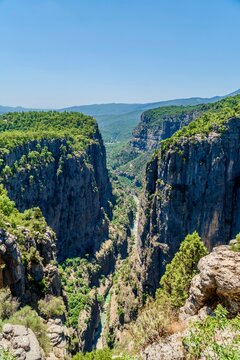 Antalya, Turkey - July 15, 2026: View of Tazy Canyon in Antalya, Turkey, showing dramatic rocky cliffs, deep canyon landscape, green forested slopes, natural rock formations, and scenic views