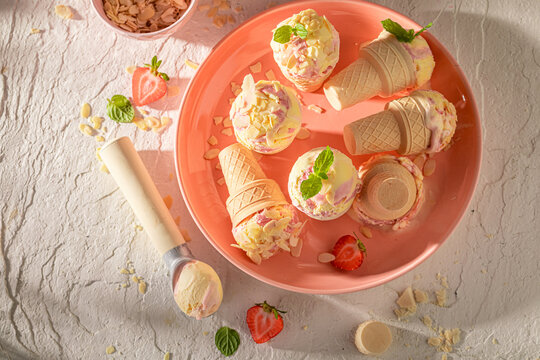 Cold and homemade strawberry ice cream made of berry fruits.
