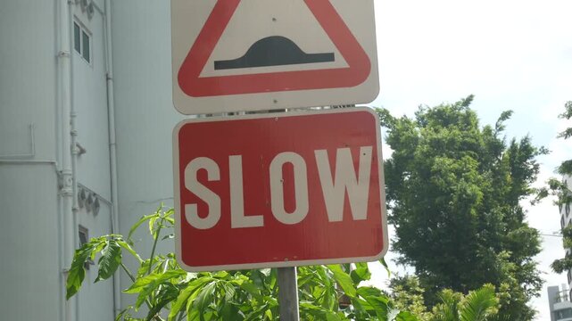 Road warning sign for speed bump and slow down instructions