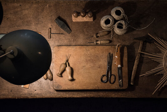 Tools and twine rolls on a wood table in a workshop
