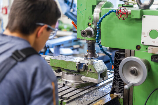 Man operating milling machine