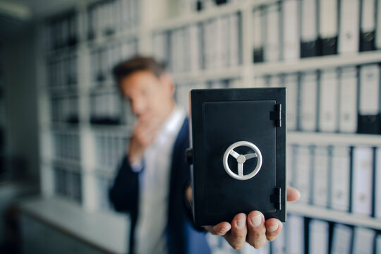 Businessman holding safe