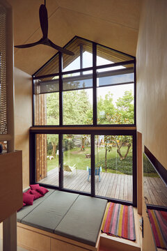 Empty bed by window in tiny house