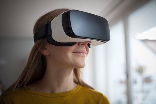 Smiling woman wearing Virtual Reality Glasses
