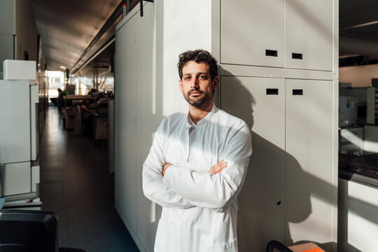 Confident doctor in white lab coat standing in hospital laboratory