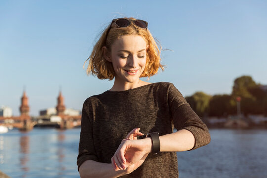 Young woman checking her smart watch