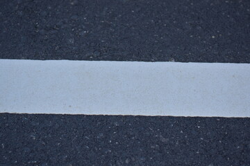 Fototapeta premium black asphalt road and white dividing lines, Asphaltic concrete road with yellow and white traffic lines, asphalt, road, surface, traffic, street, transportation, black, white, background, highway, li
