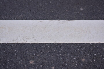 Fototapeta premium black asphalt road and white dividing lines, Asphaltic concrete road with yellow and white traffic lines, asphalt, road, surface, traffic, street, transportation, black, white, background, highway, li