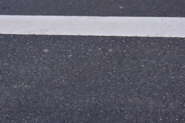 Fototapeta premium black asphalt road and white dividing lines, Asphaltic concrete road with yellow and white traffic lines, asphalt, road, surface, traffic, street, transportation, black, white, background, highway, li
