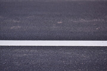 Fototapeta premium black asphalt road and white dividing lines, Asphaltic concrete road with yellow and white traffic lines, asphalt, road, surface, traffic, street, transportation, black, white, background, highway, li