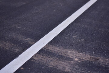 Fototapeta premium black asphalt road and white dividing lines, Asphaltic concrete road with yellow and white traffic lines, asphalt, road, surface, traffic, street, transportation, black, white, background, highway, li