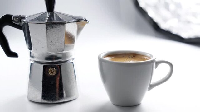 Classic Moka Pot and Fresh Espresso Cup on White Background