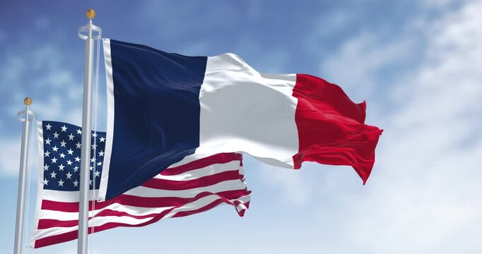 National flags of France and USA waving in the wind on a clear day